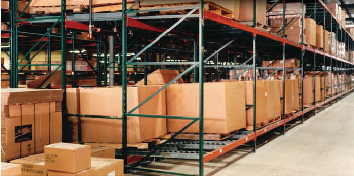 Pallet positioned in a gravity flow rack lane